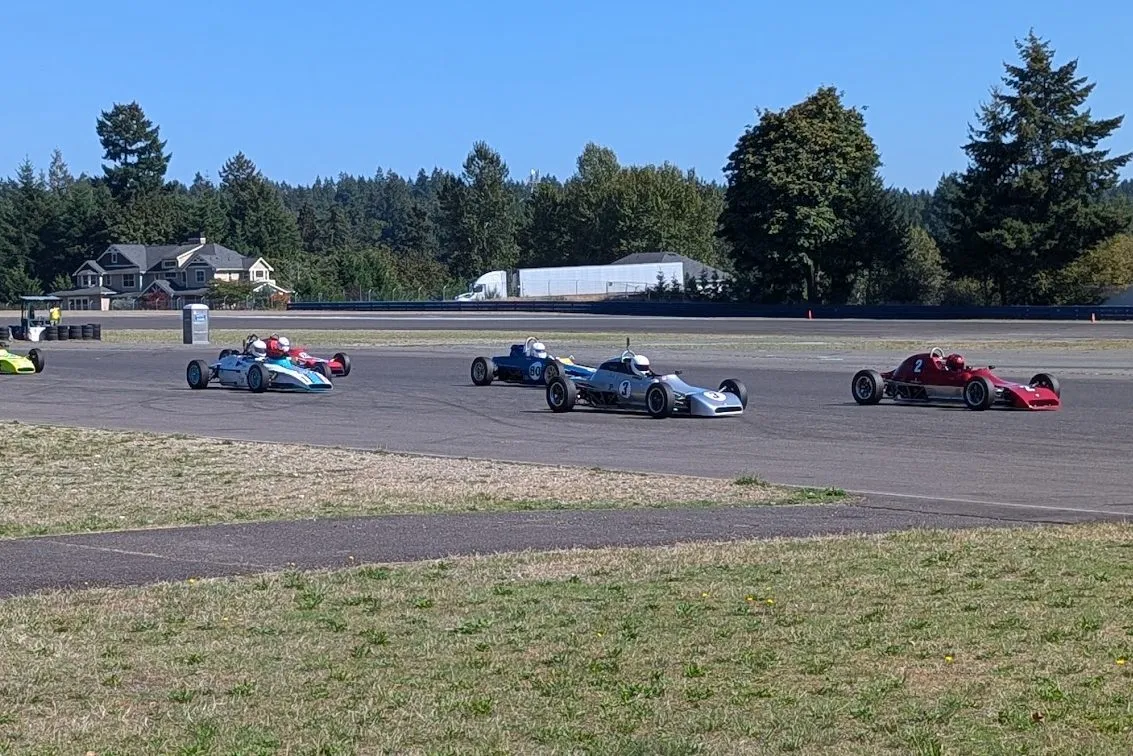 The number 3 Crosslé racing in a pack of vintage Formula Fords