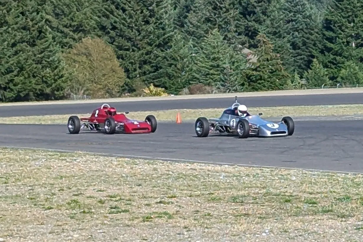 The number 3 Crosslé racing wheel to wheel with a red number 2