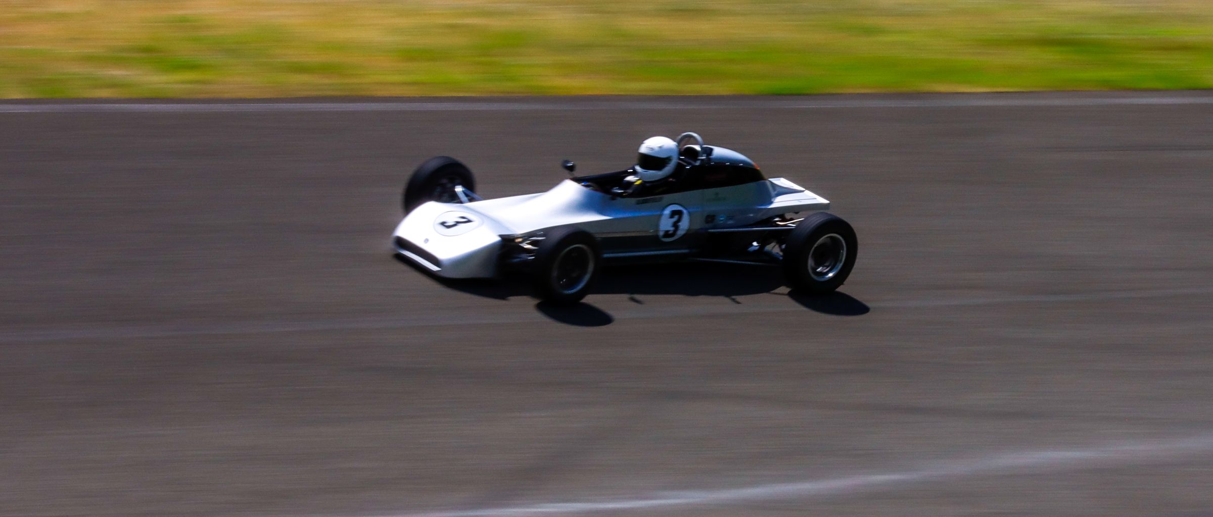 Bill Krutilla in the silver number 3 Crosslé 35F at speed, side view