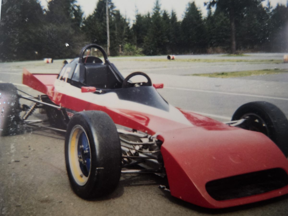 The car in red, black, and white as number 25, front view