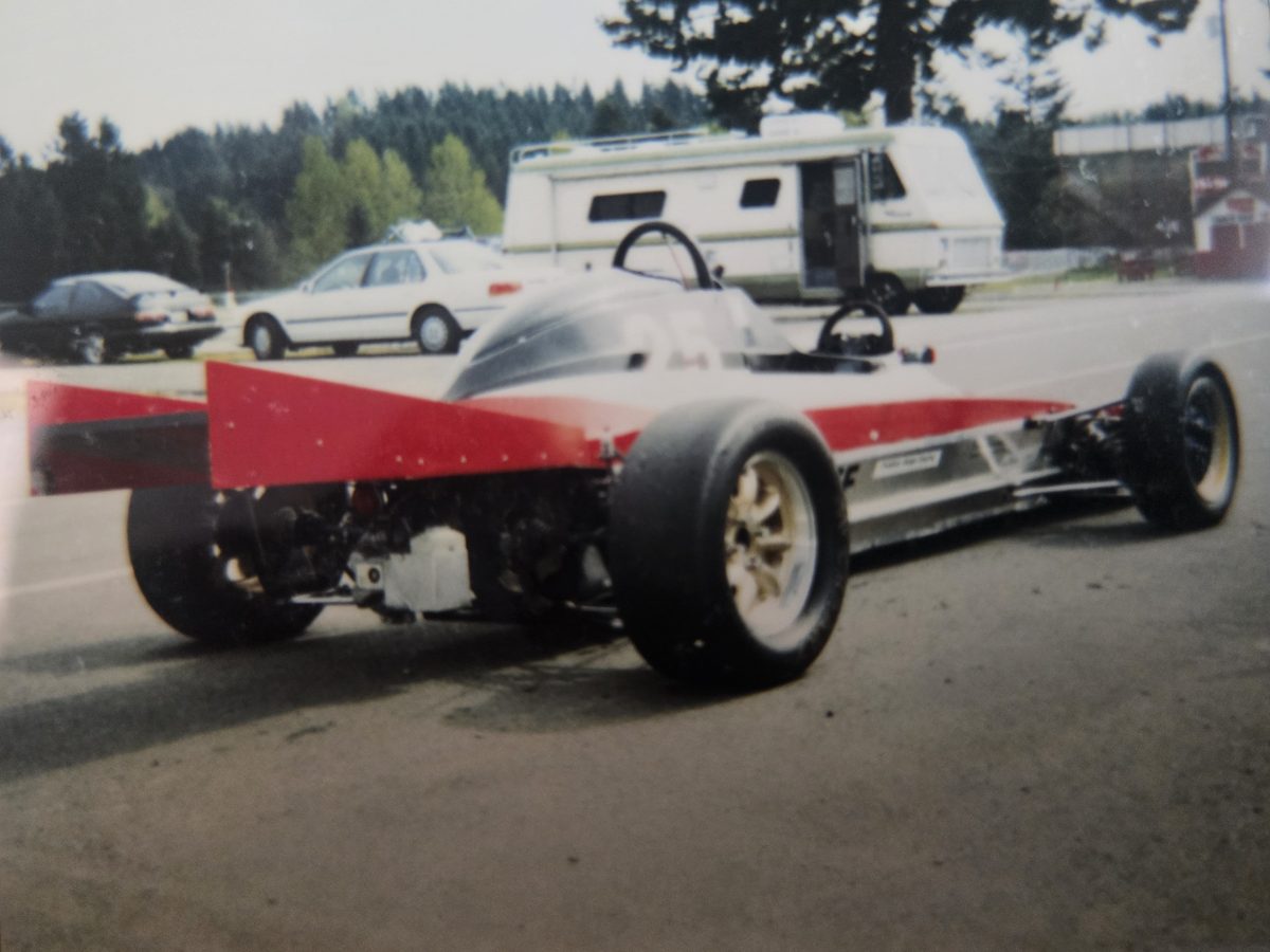 The car in red, black, and white, rear view
